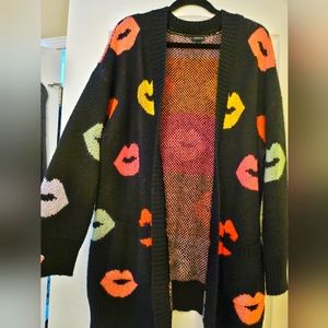 Black open front chunky cardigan with kisses from Torrid.